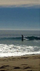 annemarie surfing her longboard at porto de mos