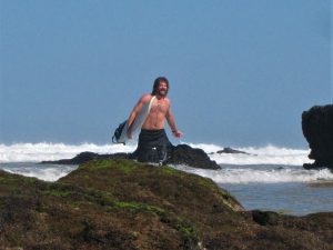 stoked surfer walking out of the water