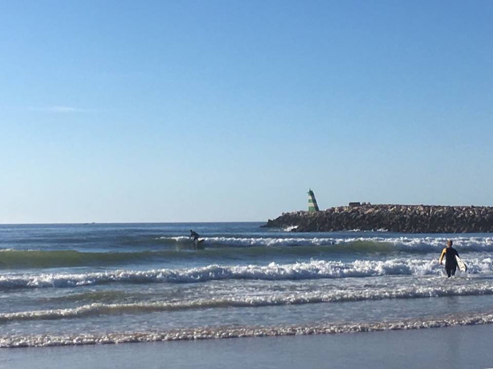 meia praia surfgirl walking in the water