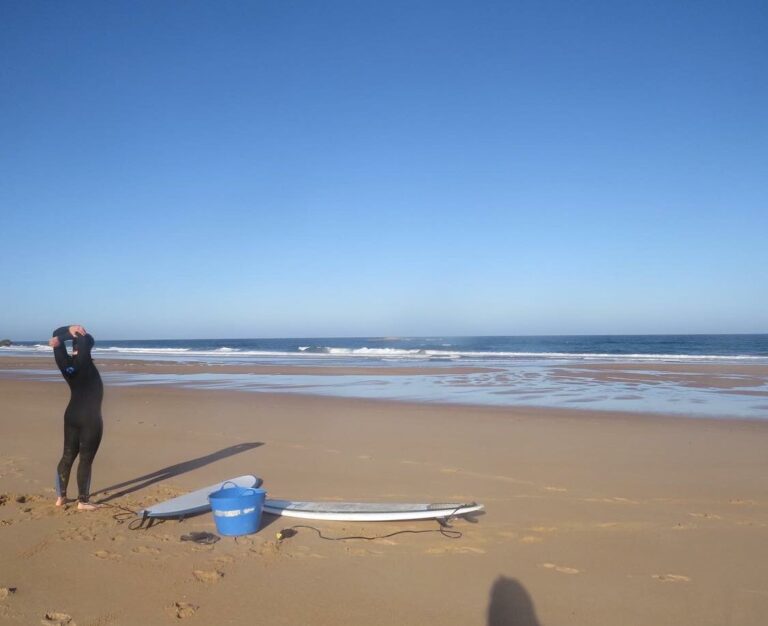 amado beach empty surfer warm up surf guide algarve