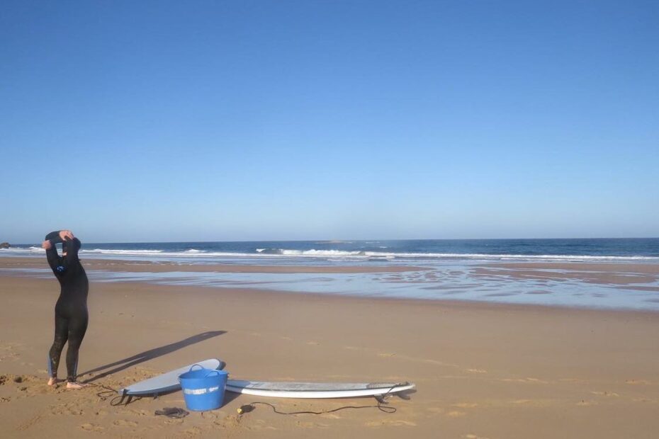 amado beach empty surfer warm up surf guide algarve