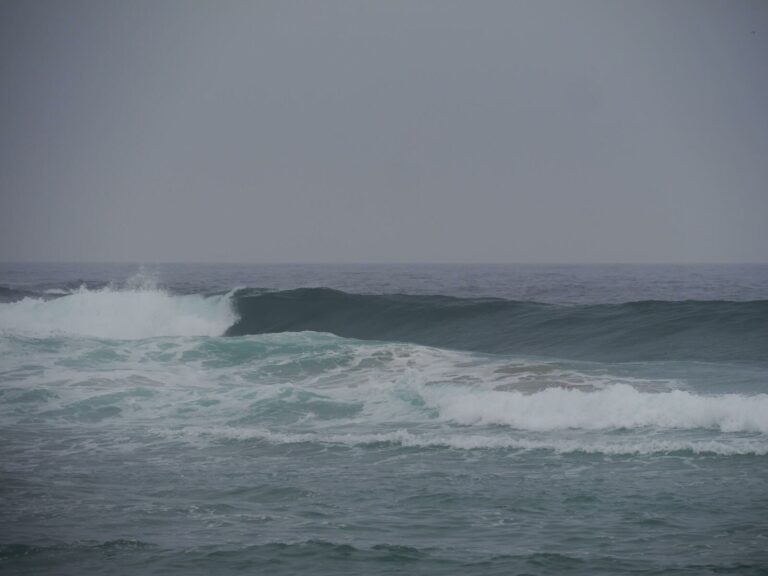 empty glassy waves rolling in at Castelejo