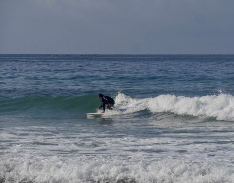 surf guide algarve guest enjoying small waves at zavial