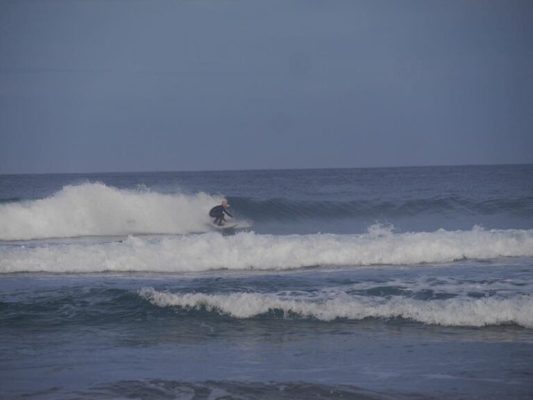 going left on a glassy wave with surf guide algarve