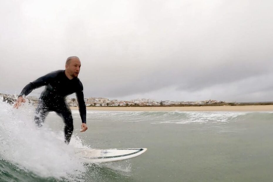 surf guide algarve guest enjoying the clean waves in lagos meia praia