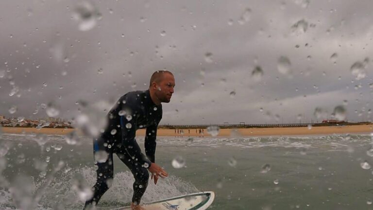 surfing in the rain, lagos meia praia with surf guide algarve