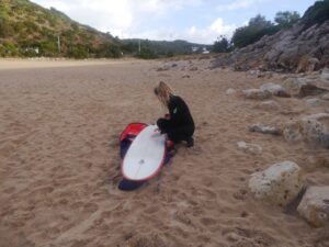 waxing the surfboard at zavial surf guide algarve