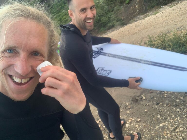 waxing up surfboards and faces surf guide algarve
